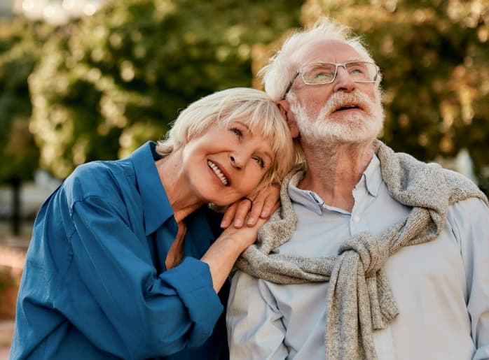 Happy senior couple looking at the sky.